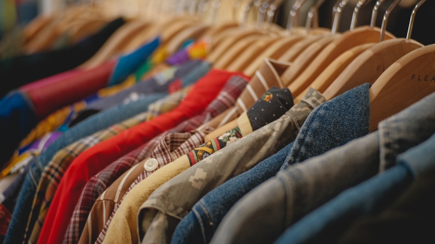 A rack of vintage flannels, denim, and older clothing — the kind of pieces we buy on the spot.